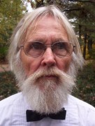 Older man with glasses and white hair, beard and mustache